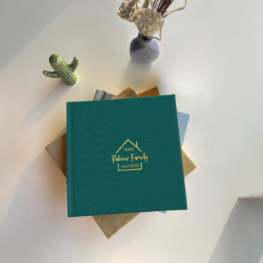 Premium Layflat Family Photo Album With a Teal Green Linen Cover and Custom Embossing in Gold